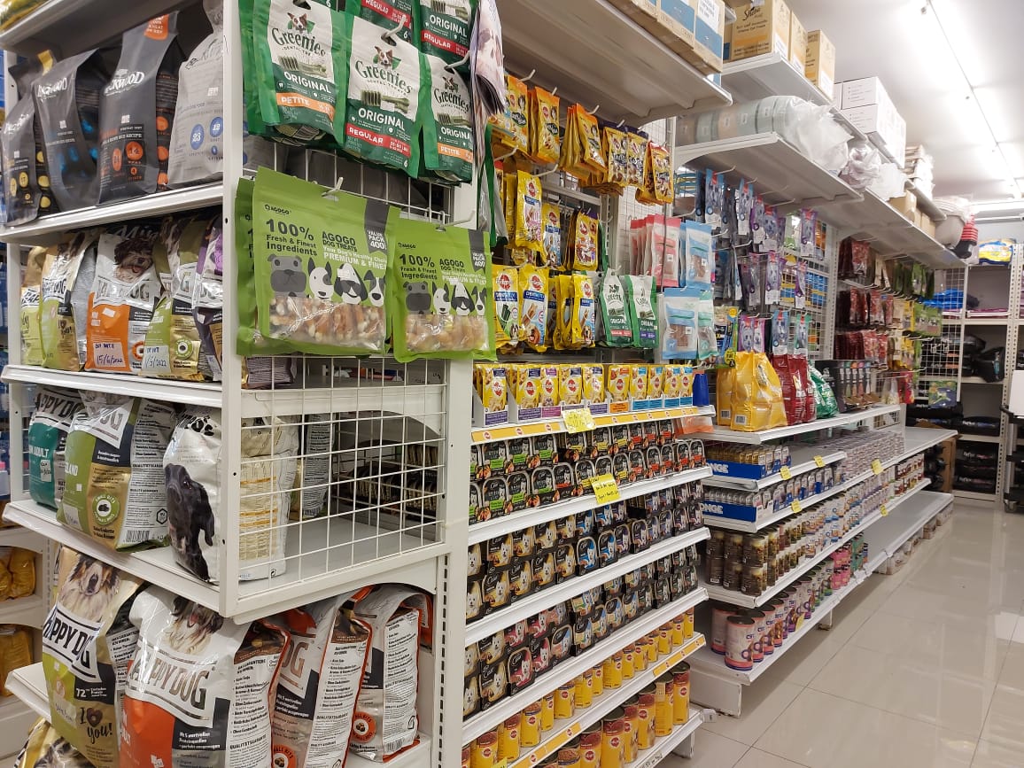 Shelves stocked with pet food and treats inside Exotic Hyper Pets Centre